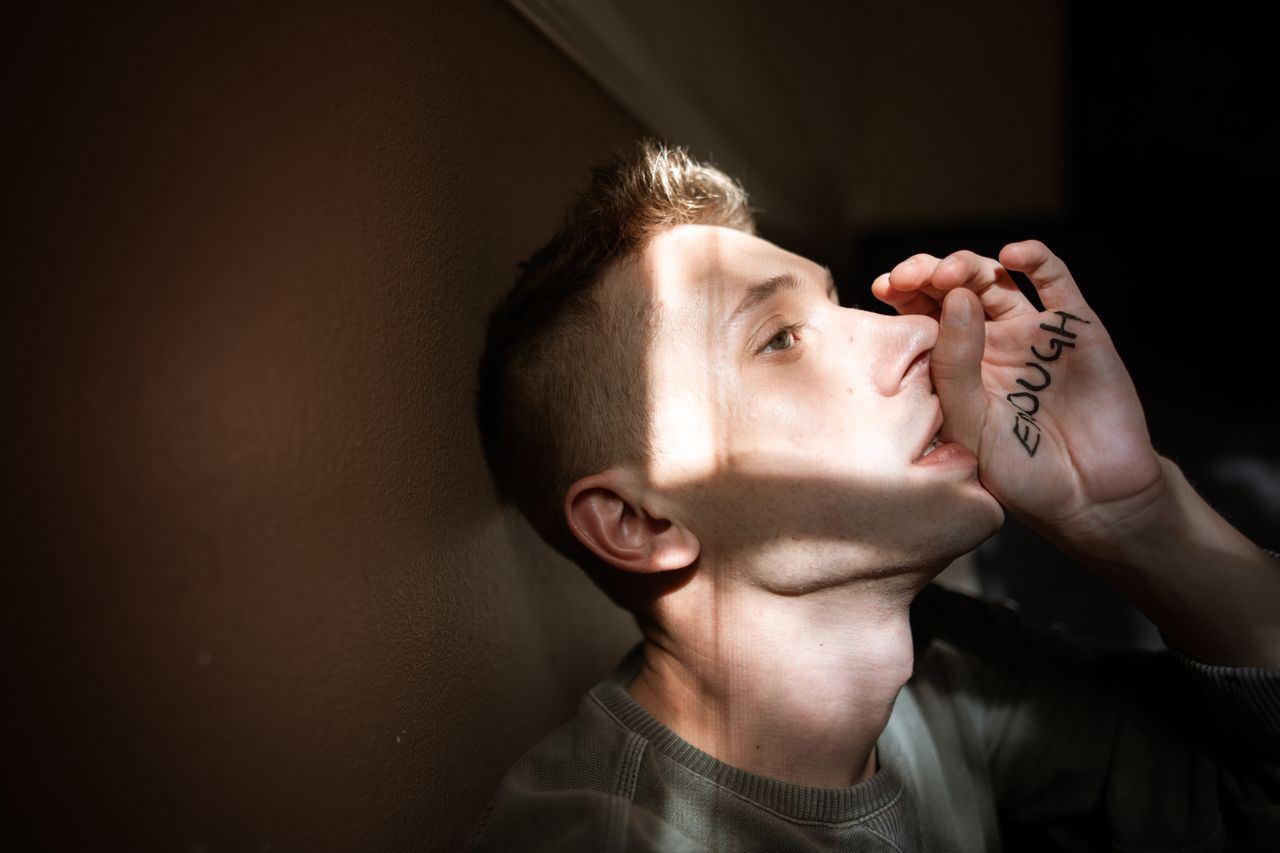 Understanding PTSD Symptoms and Finding Therapy Near Me A powerful portrait of a young man expressing empowerment and self-awareness.