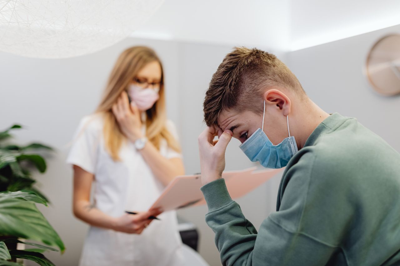 PHP vs. IOP: Which Treatment Is Right for You? A worried patient discusses with a healthcare professional in a medical office setting.